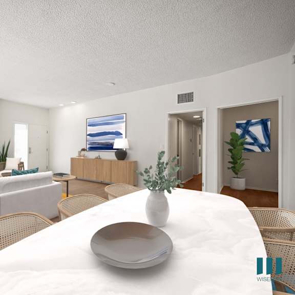a living room and dining room with a white table and chairs