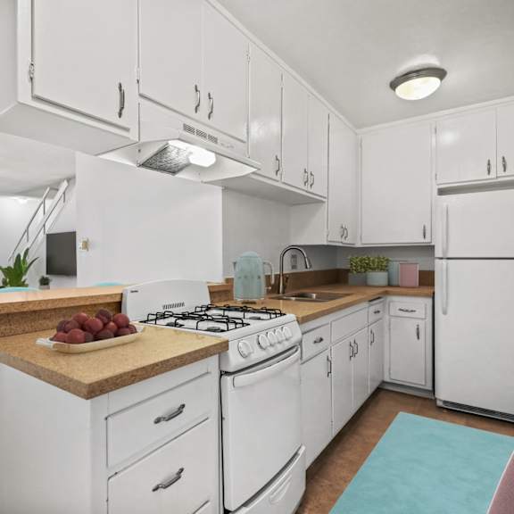 kitchen with a stove oven, refrigerator, and ample cabinet storage