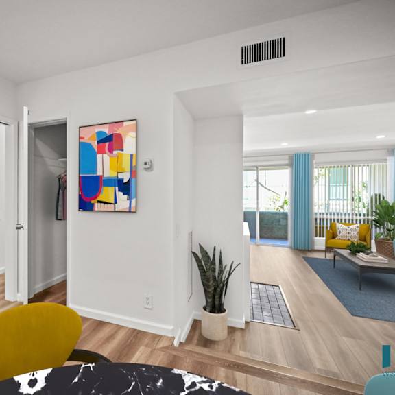 a living room with a yellow chair and a painting on the wall.