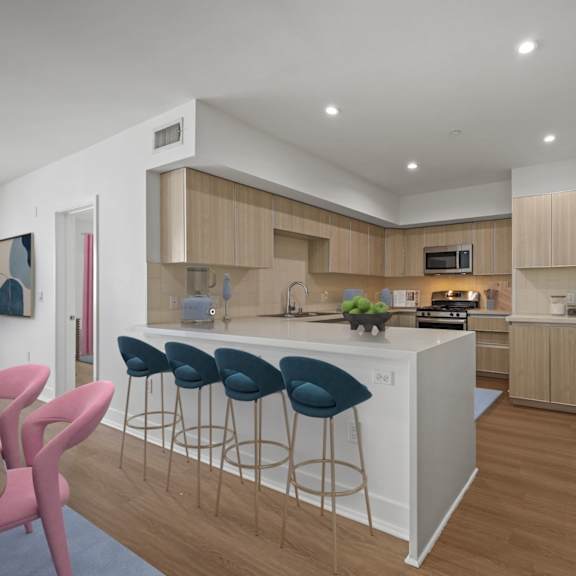 kitchen with countertop bar, stainless-steel appliances, and ample cabinet storage