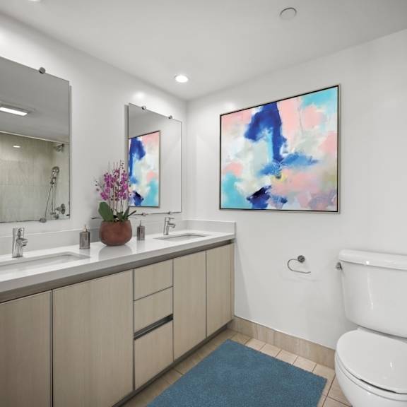 spacious bathroom with double-sink vanity and cabinet storage