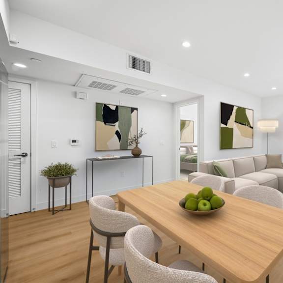 a modern dining room with a wooden table and chairs.