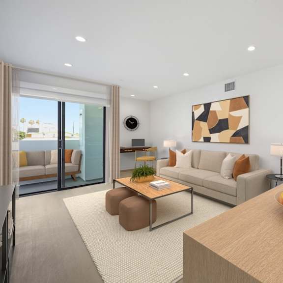 a modern living room with a wooden table and a bowl of fruit on it.