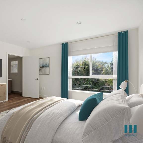 a bedroom with a bed and a tv on the wall