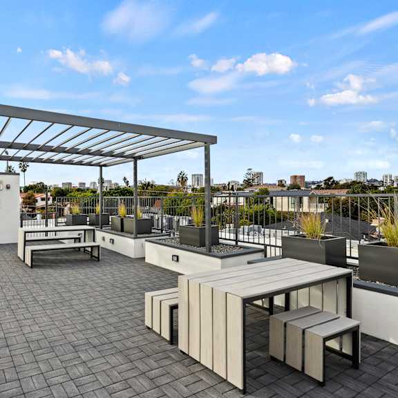 a patio with a table and chairs under a roof.