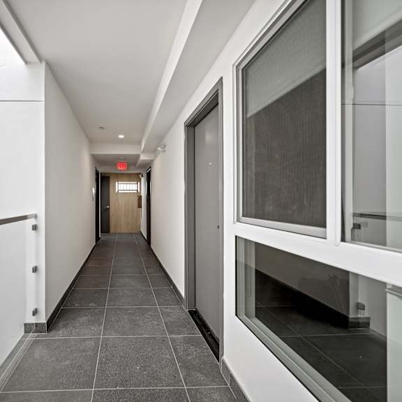 a long hallway with a door at the end.