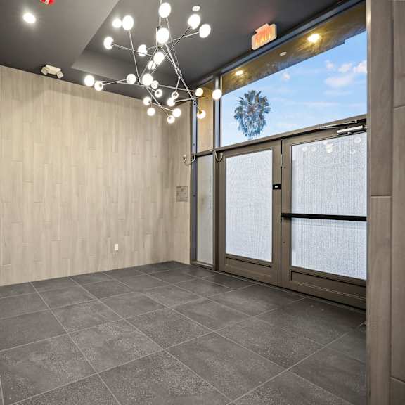 a room with a grey floor and wooden walls.