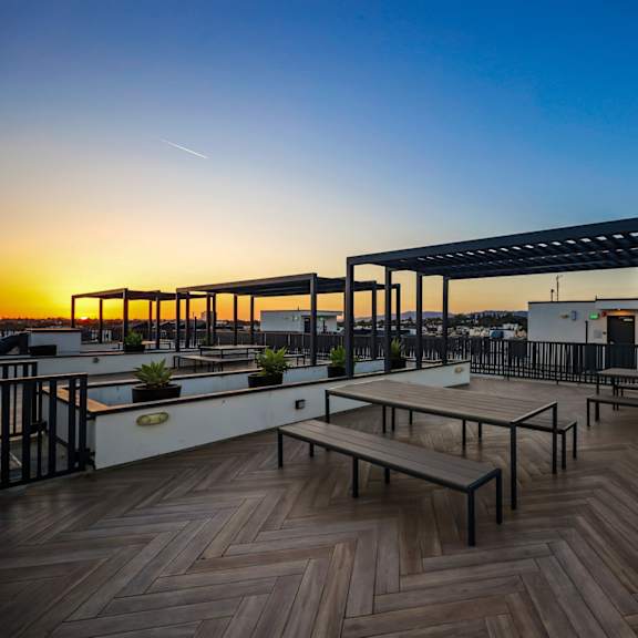 rooftop deck with entertainment area and pergola
