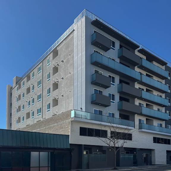 a modern building with a mix of concrete and glass facade.