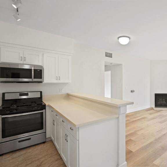 open-concept kitchen, dining, and living room areas