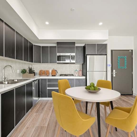 kitchen with yellow chairs and table at ogden garden by wiseman, los angeles