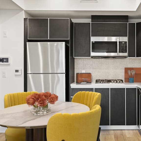 gourmet kitchen with island at ogden garden by wiseman, los angeles, 90036