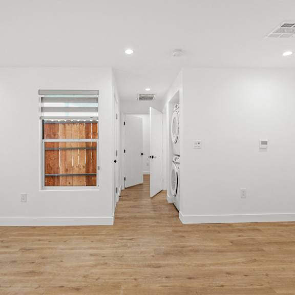 living room with vinyl flooring, recessed lighting, and in-suite washer & dryer