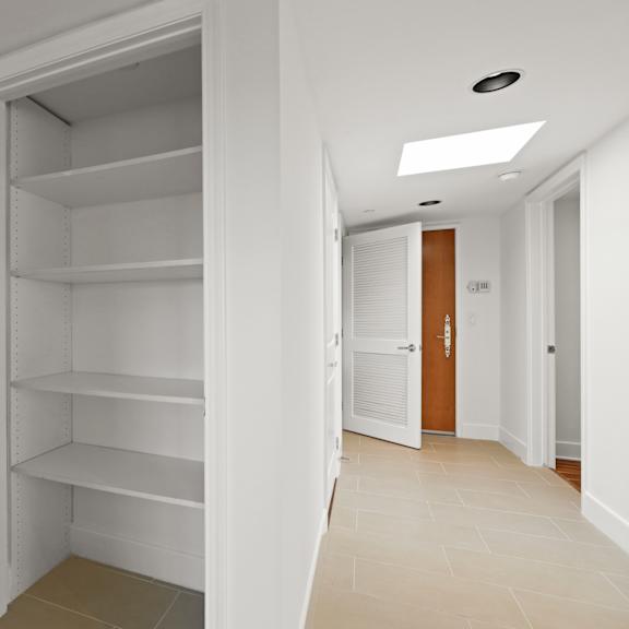 hall closet with built-in shelving