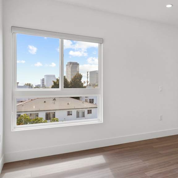 bedroom with closet, windows, and vinyl  flooring