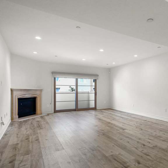 large living room with a fireplace and balcony
