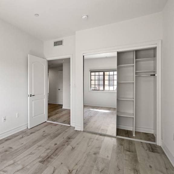 bedroom with closet with a built-in organization system