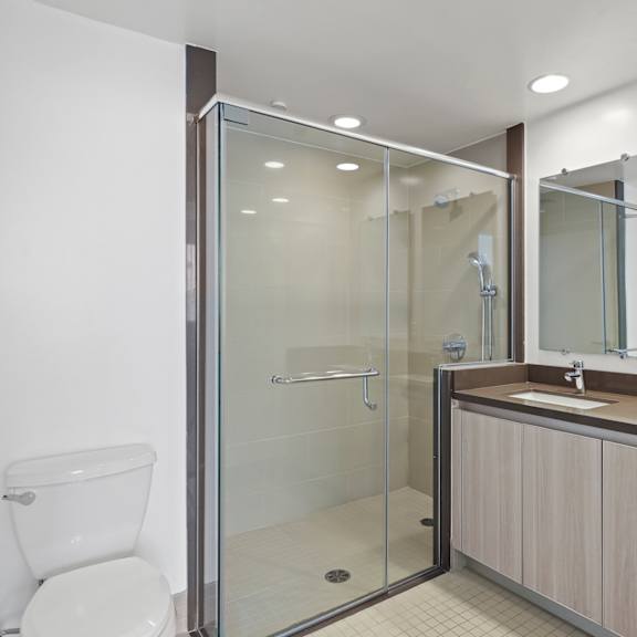 master bathroom with walk-in shower and double-sink vanity