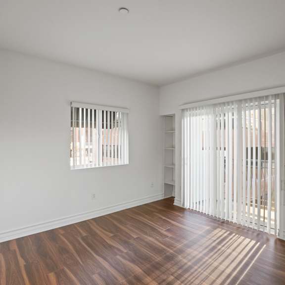 bedroom with built-in shelving and balcony