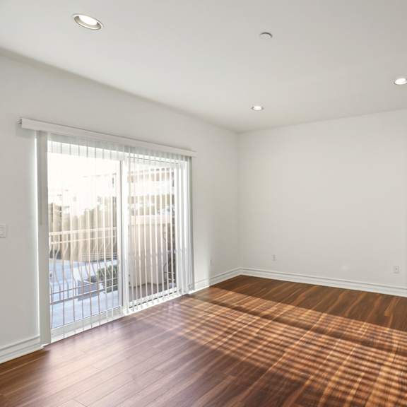 bedroom with closet, balcony, and vinyl flooring
