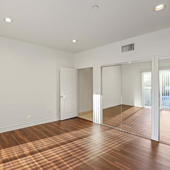 large-size bedroom with double closets and vinyl flooring