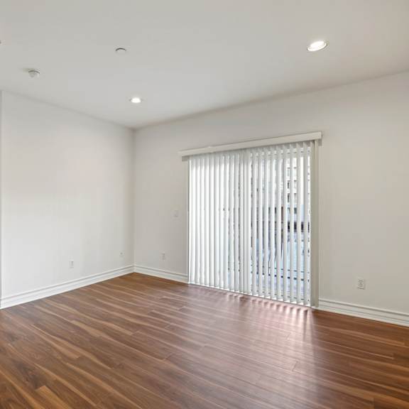 living room space with in-suite alarm system, recess lighting, and balcony