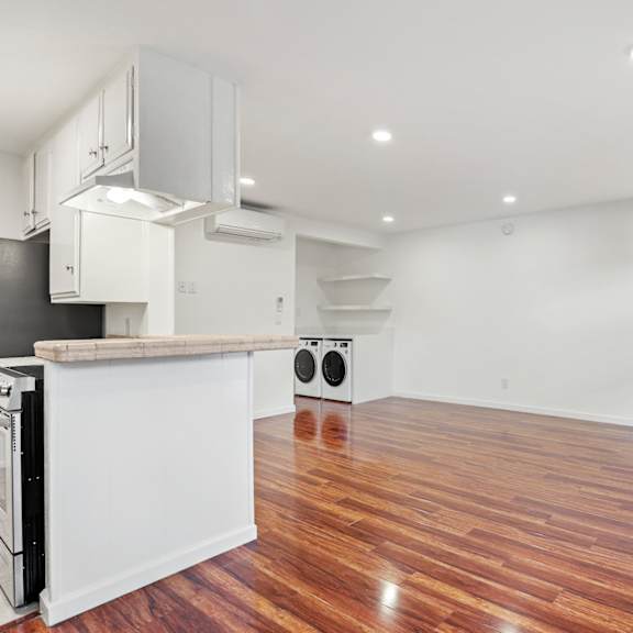 kitchen, dining, and living room space with recessed lighting, vinyl flooring, and large windows