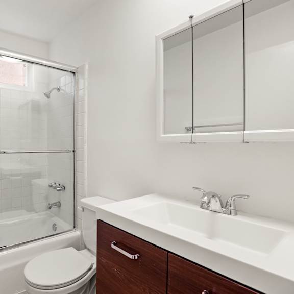 bathroom with a bathtub and glass doors