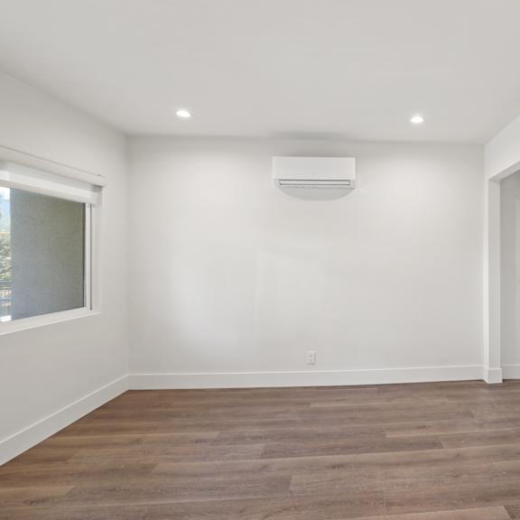 bedroom with wall heater and closet