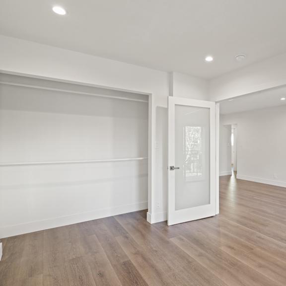 apartment bedroom with double entry doors and large closet
