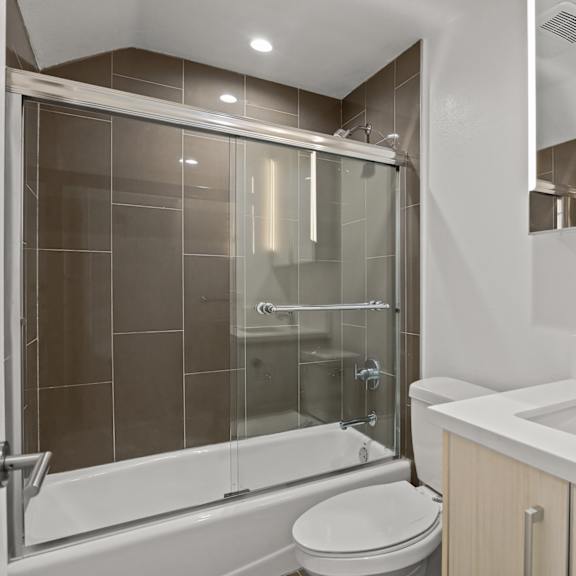 west la apartment bathroom with full-size bathtub