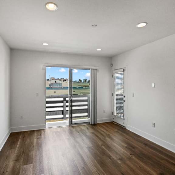 living room with vinyl flooring and balcony