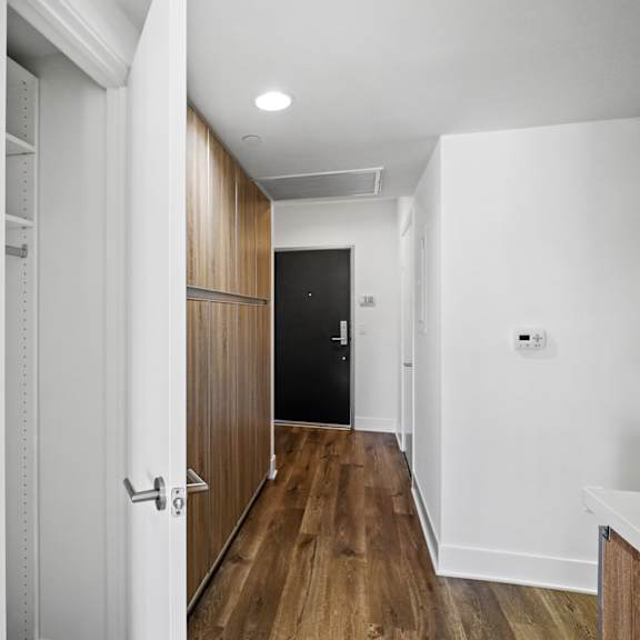 hallway with closet and cabinet storage