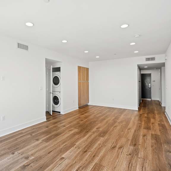 living room with vinyl flooring and in-suite washer & dryer