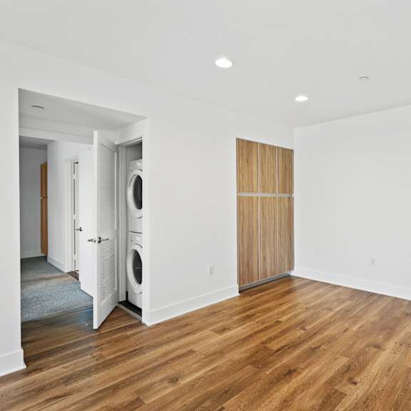 living room space with cabinet storage and in-suite washer & dryer