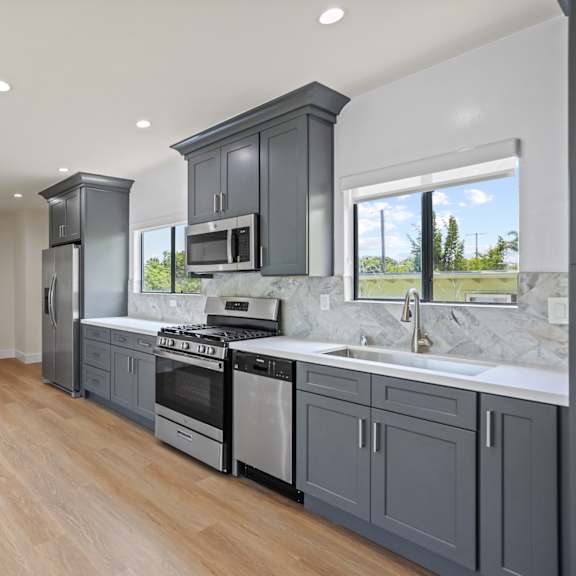 open-concept kitchen, dining, and living room areas