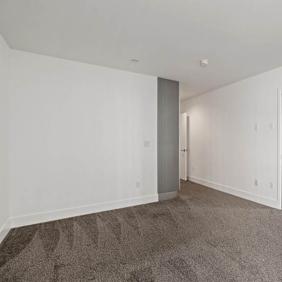 bedroom with mirrored closet and additional cabinet storage
