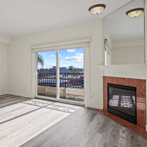 large-size living room area with an electric fireplace and a private balcony