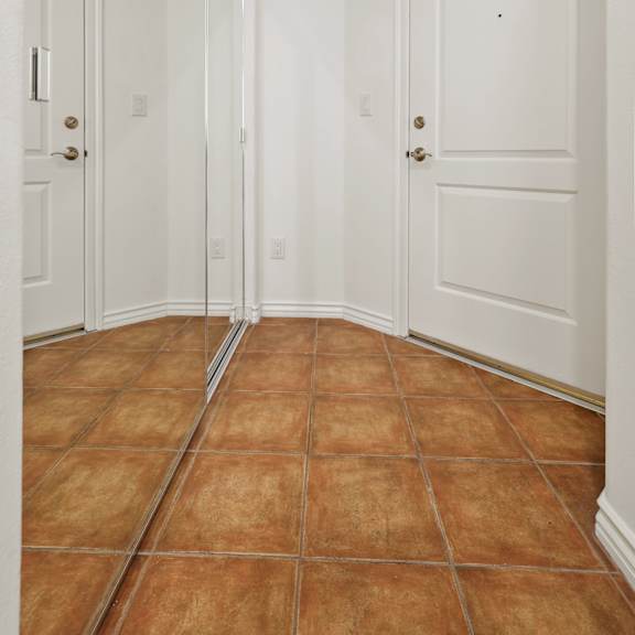 entryway with large mirrored storage closet