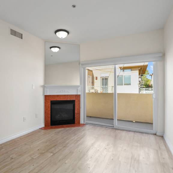 living room space with electric fireplace and private balcony