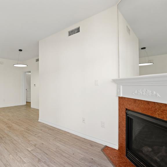 open-concept dining and living room with electric fireplace