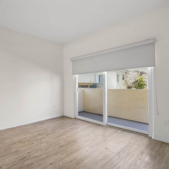 spacious bedroom with mirrored closet and private balcony