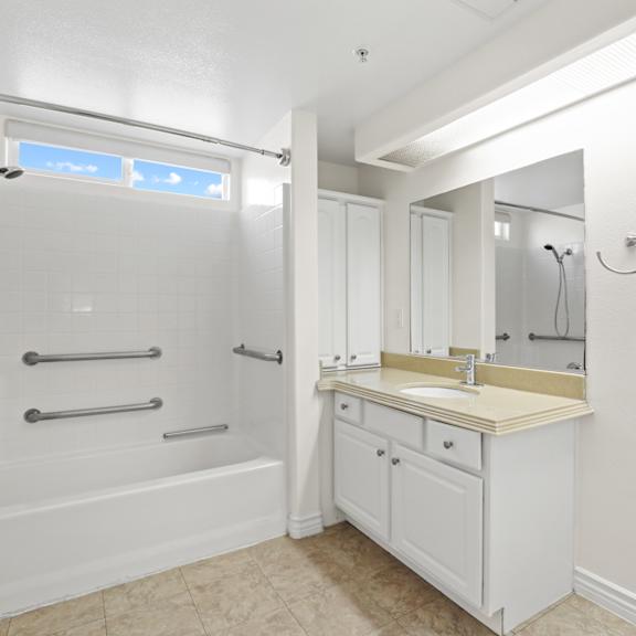 large handicap accessible bathroom with full-size bathtub