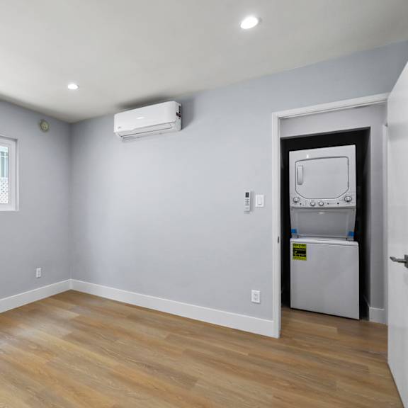 bedroom with recessed lighting, vinyl flooring, and windows