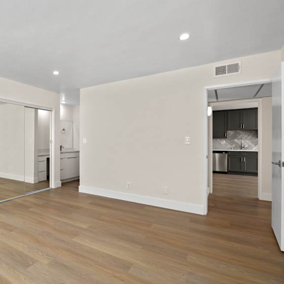 large size bedroom with double mirrored closet and full-size bathroom