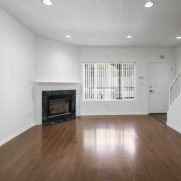 living room with electric fireplace, recessed lighting, vinyl flooring, and patio