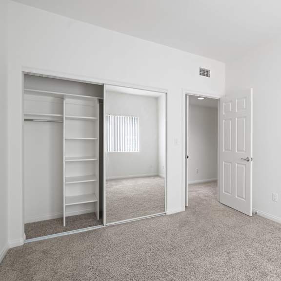 bedroom with closet with built-in shelving