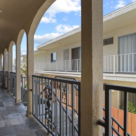 a long corridor with balconies at the whispering winds apartments in pearland, tx