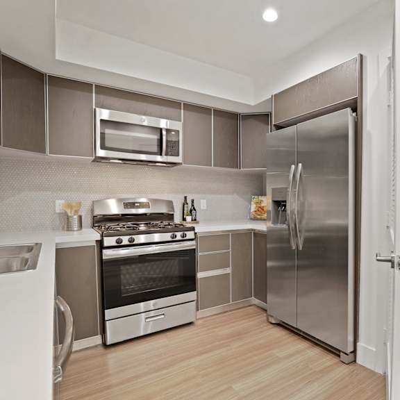 stainless-steel kitchen appliances with in-suite washer & dryers