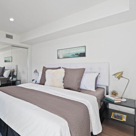 bedrooms with large mirrored closet space and additional cabinet storage